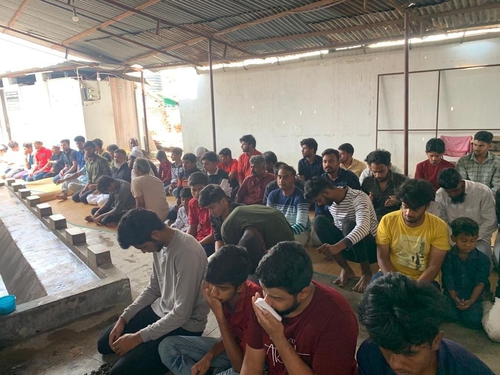 Worshippers praying outside